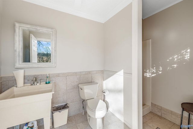 bathroom featuring tile walls, toilet, vanity, walk in shower, and tile patterned floors