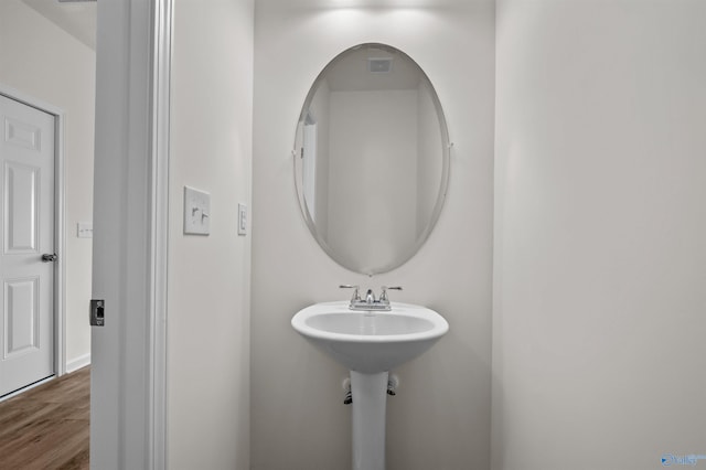 bathroom with wood-type flooring