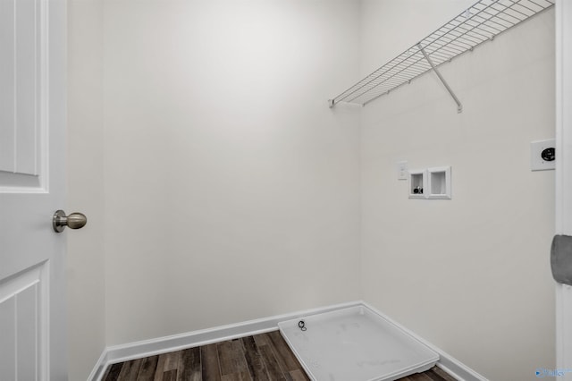 clothes washing area featuring electric dryer hookup, hookup for a washing machine, and hardwood / wood-style flooring