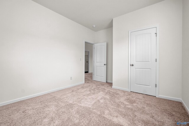 unfurnished bedroom featuring light colored carpet