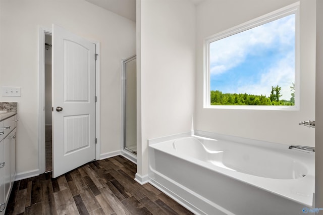 bathroom featuring separate shower and tub, hardwood / wood-style floors, and vanity