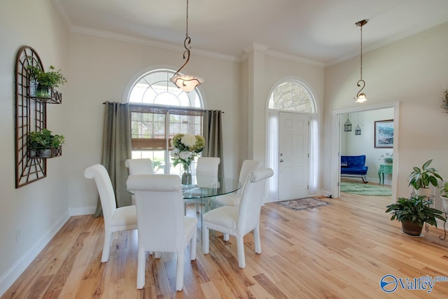 227 Lee Bowden Dr, Huntsville, AL 35806 - dining room with crown molding, light wood-type flooring, and baseboards