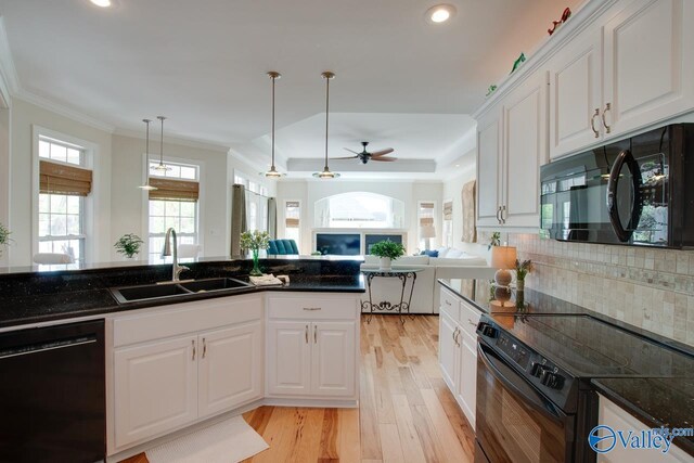 227 Lee Bowden Dr, Huntsville, AL 35806 - kitchen with black appliances, a sink, light wood-type flooring, recessed lighting, and a raised ceiling