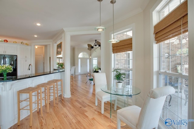 227 Lee Bowden Dr, Huntsville, AL 35806 - kitchen featuring freestanding refrigerator, crown molding, light wood finished floors, a kitchen breakfast bar, and a ceiling fan