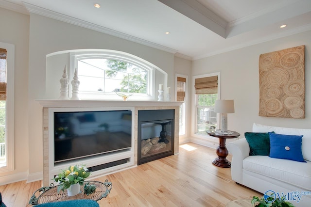 227 Lee Bowden Dr, Huntsville, AL 35806 - living room with healthy amount of natural light, wood finished floors, crown molding, a glass covered fireplace, and recessed lighting