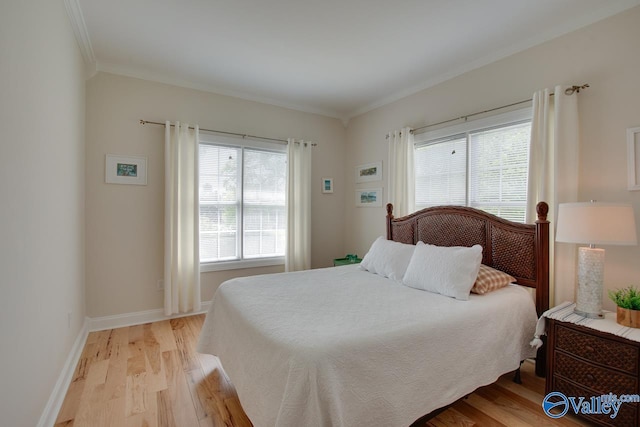 227 Lee Bowden Dr, Huntsville, AL 35806 - bedroom featuring light wood finished floors, crown molding, and baseboards