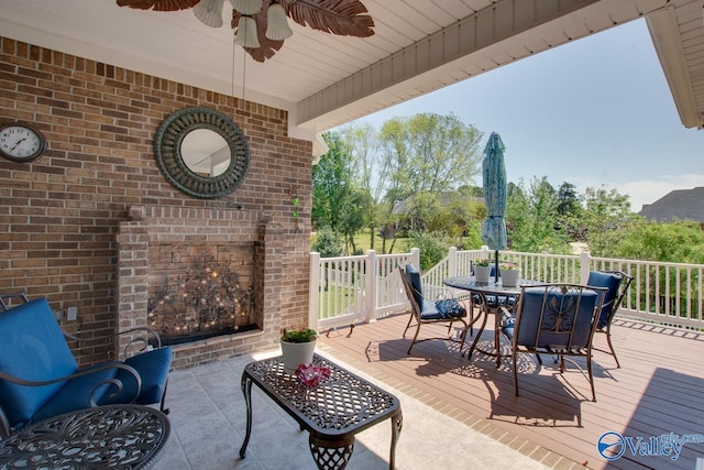 227 Lee Bowden Dr, Huntsville, AL 35806 - view of patio / terrace featuring outdoor dining area, a ceiling fan, a wooden deck, and an outdoor brick fireplace