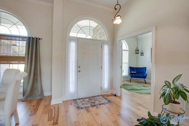 227 Lee Bowden Dr, Huntsville, AL 35806 - entryway featuring light wood-type flooring, healthy amount of natural light, crown molding, and baseboards