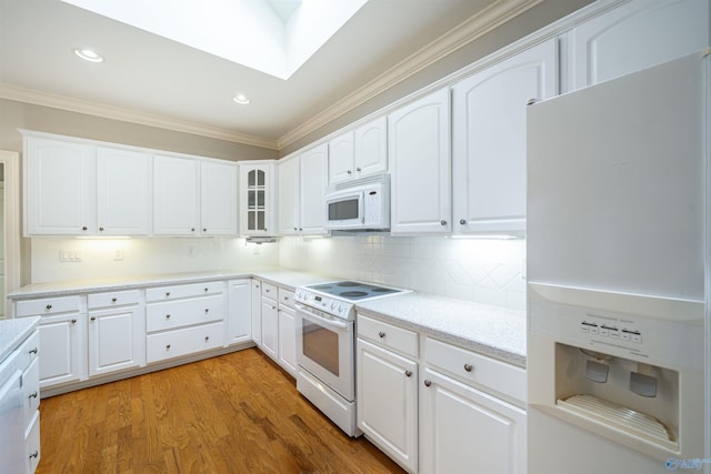 kitchen featuring white cabinetry, white appliances, crown molding, light wood finished floors, and decorative backsplash