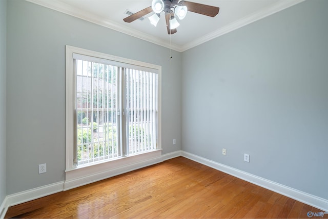 spare room with a ceiling fan, baseboards, light wood-type flooring, and ornamental molding