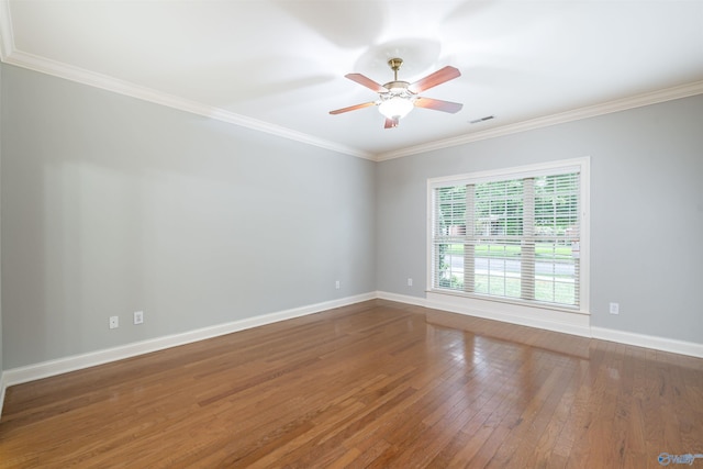 unfurnished room with baseboards, crown molding, ceiling fan, and wood-type flooring