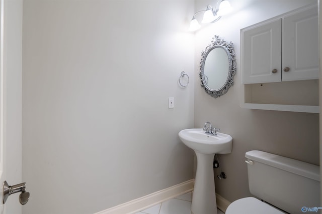 bathroom with tile patterned flooring, toilet, and baseboards