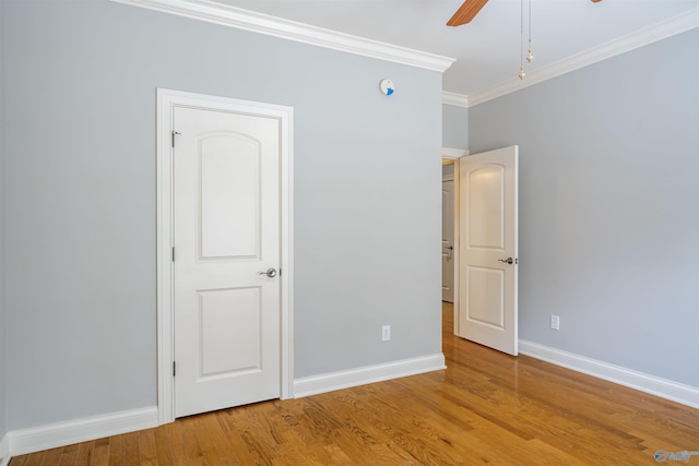 unfurnished bedroom featuring light wood-type flooring, baseboards, and ornamental molding