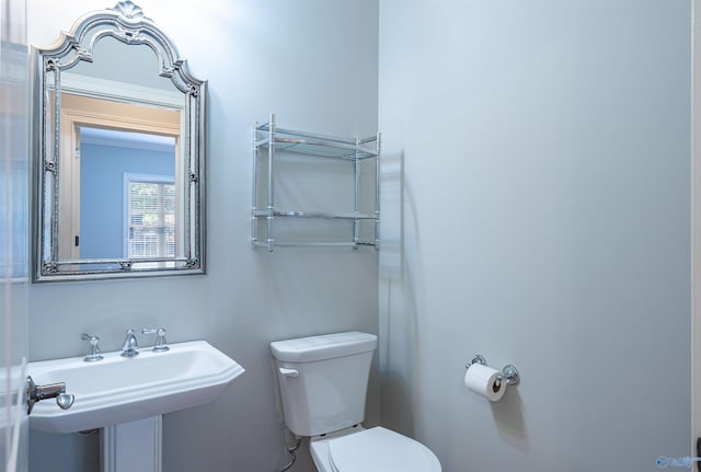 half bathroom with a sink and toilet