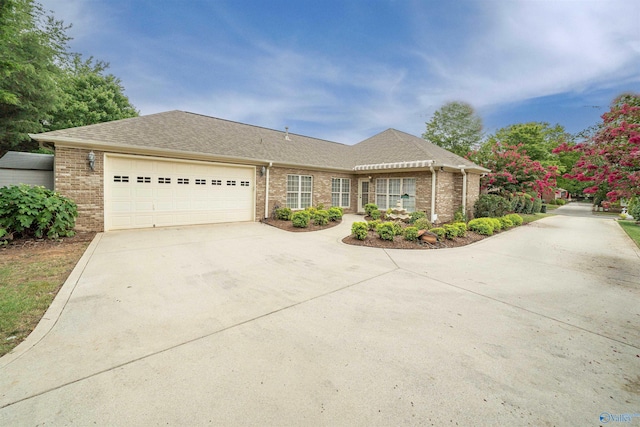 ranch-style home featuring a garage, brick siding, driveway, and a shingled roof