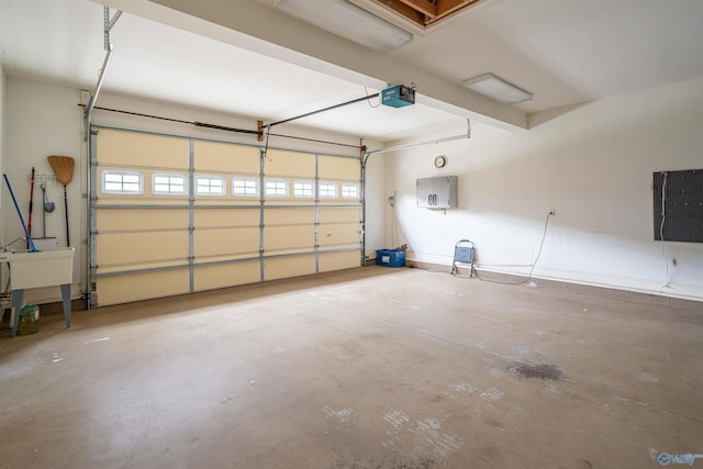 garage featuring electric panel and a garage door opener