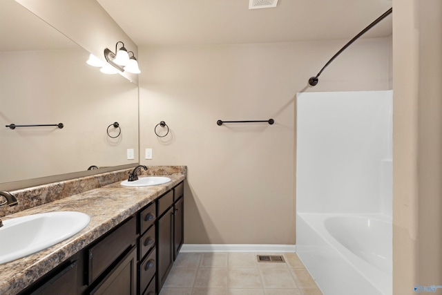 bathroom featuring double vanity, visible vents, a sink, and tile patterned floors