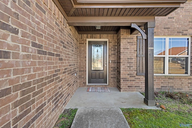 view of exterior entry with brick siding