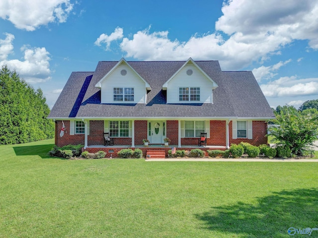 cape cod-style house with a front yard and covered porch