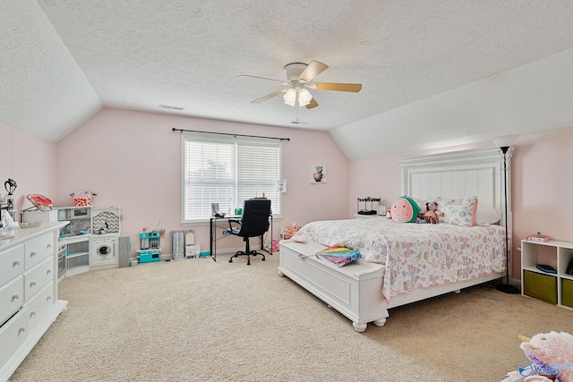 carpeted bedroom with lofted ceiling, a ceiling fan, visible vents, and a textured ceiling