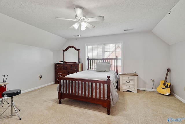 carpeted bedroom featuring visible vents, ceiling fan, baseboards, vaulted ceiling, and a textured ceiling