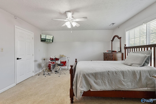 carpeted bedroom featuring visible vents, baseboards, vaulted ceiling, a textured ceiling, and a ceiling fan