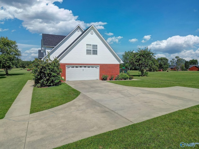 view of side of property featuring a yard, brick siding, concrete driveway, and an attached garage