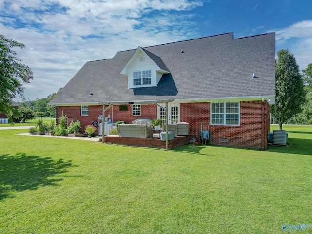 back of property with brick siding, outdoor lounge area, and a yard