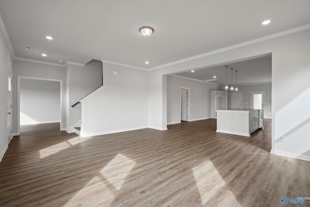 unfurnished living room with sink, crown molding, and dark wood-type flooring