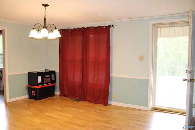 unfurnished dining area with wood finished floors and a healthy amount of sunlight