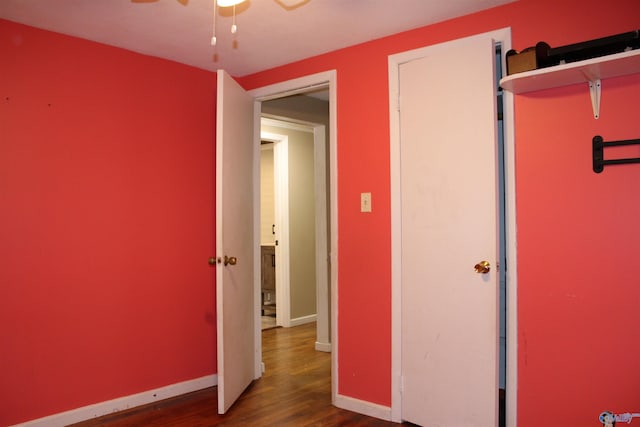 unfurnished bedroom featuring baseboards and wood finished floors
