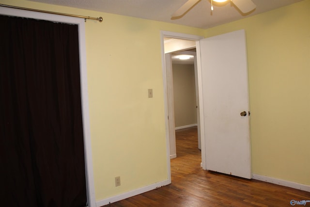 spare room with baseboards, a ceiling fan, and wood finished floors