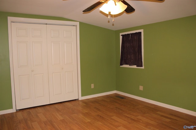 unfurnished bedroom with baseboards and wood finished floors