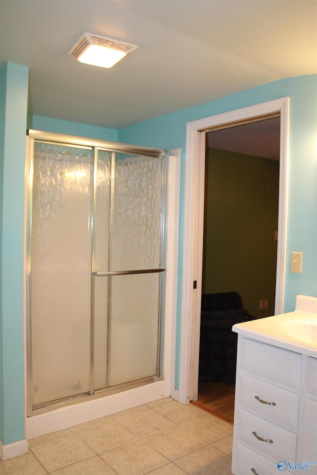 full bathroom with vanity, tile patterned flooring, and a stall shower