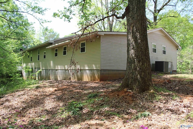 view of side of home featuring central AC unit