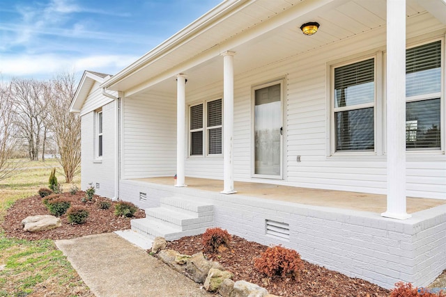 entrance to property featuring crawl space and covered porch