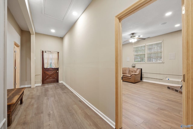 hallway with light hardwood / wood-style floors