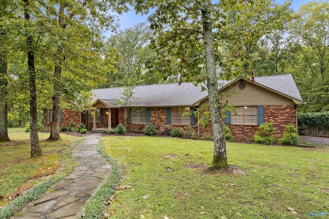 ranch-style house featuring brick siding and a front lawn