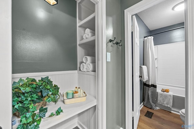 bathroom featuring shower / tub combo, wood finished floors, and visible vents