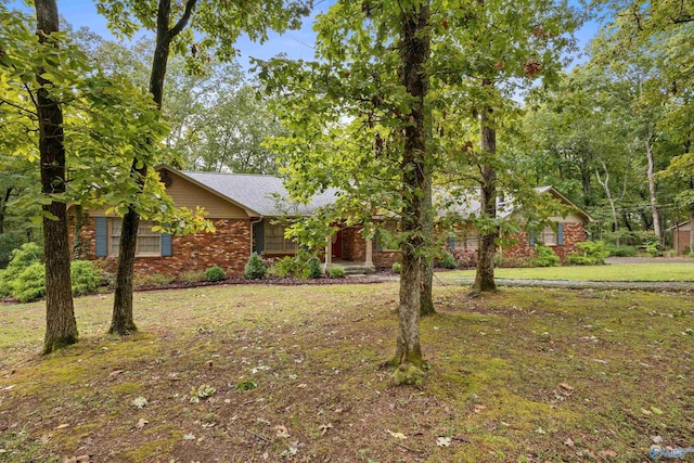 ranch-style house with brick siding and a front yard