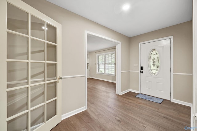 entryway with baseboards and wood finished floors
