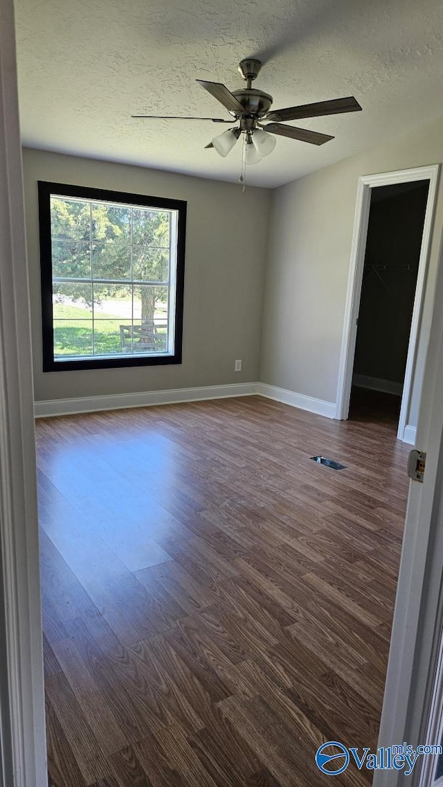 7739 Allison Loop, Athens, AL 35611 - spare room featuring dark wood-style floors, a textured ceiling, baseboards, and ceiling fan