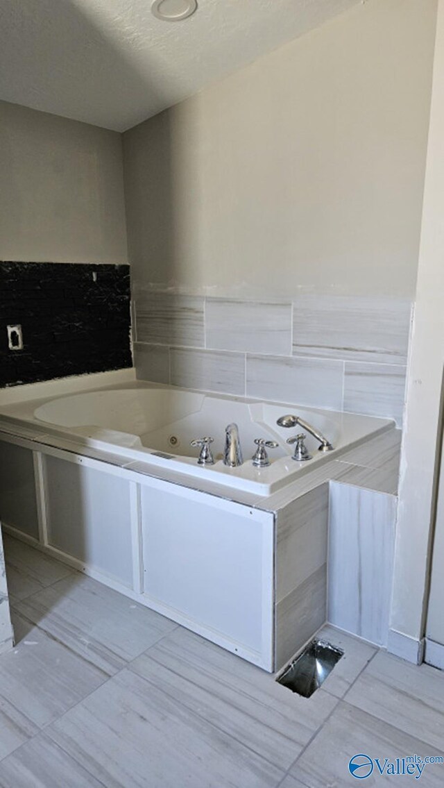7739 Allison Loop, Athens, AL 35611 - bathroom featuring a textured ceiling and a jetted tub