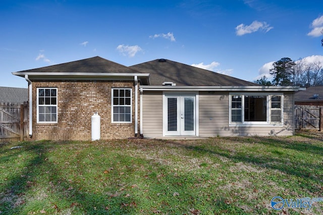 back of house featuring a yard and french doors