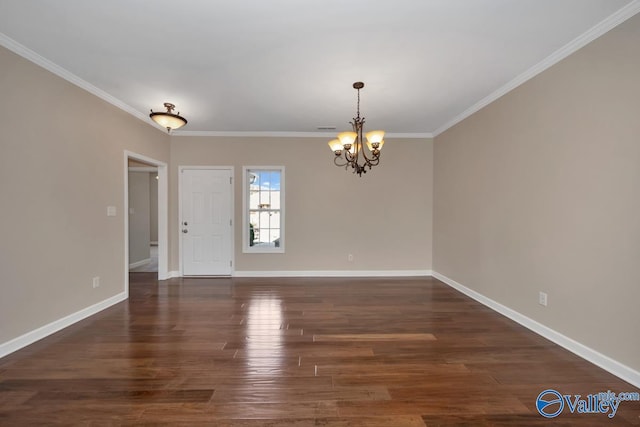 spare room with dark hardwood / wood-style floors, an inviting chandelier, and ornamental molding