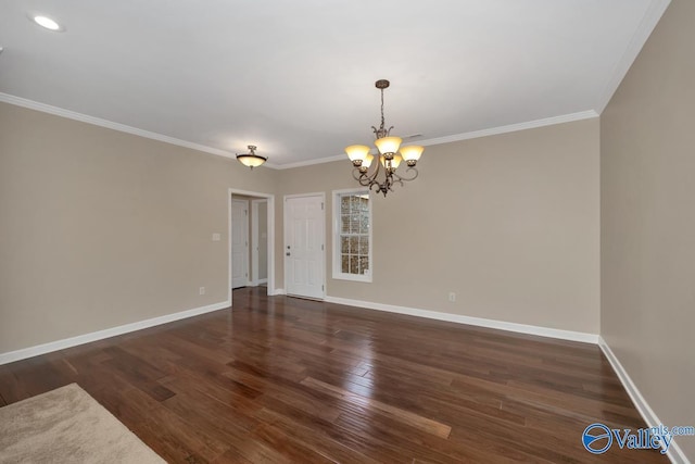 empty room featuring dark hardwood / wood-style flooring, an inviting chandelier, and ornamental molding