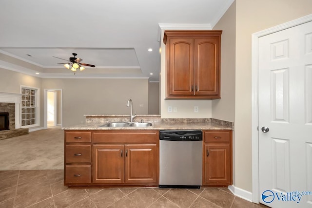 kitchen with a raised ceiling, ceiling fan, sink, and stainless steel dishwasher