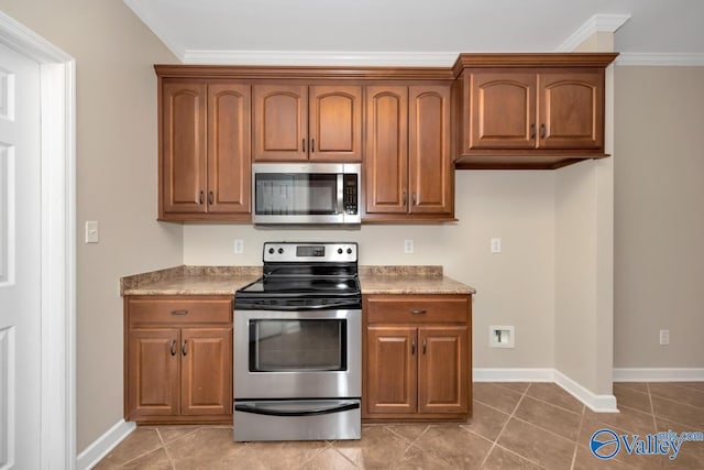 kitchen featuring appliances with stainless steel finishes, tile patterned floors, and ornamental molding