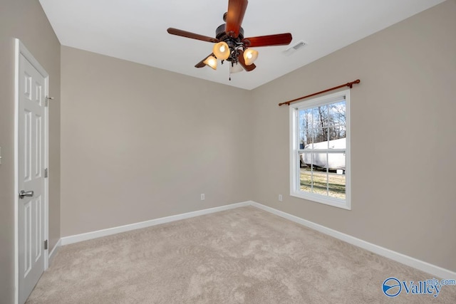 carpeted empty room featuring ceiling fan