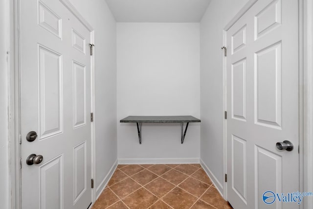 walk in closet featuring dark tile patterned flooring